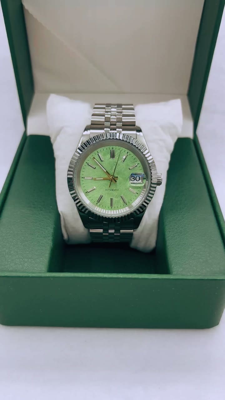 A green day-date watch on a steel bracelet